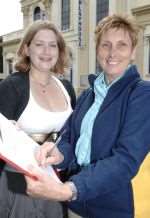 Reporter Liz Crudgington collects a signature from Jackie Wells