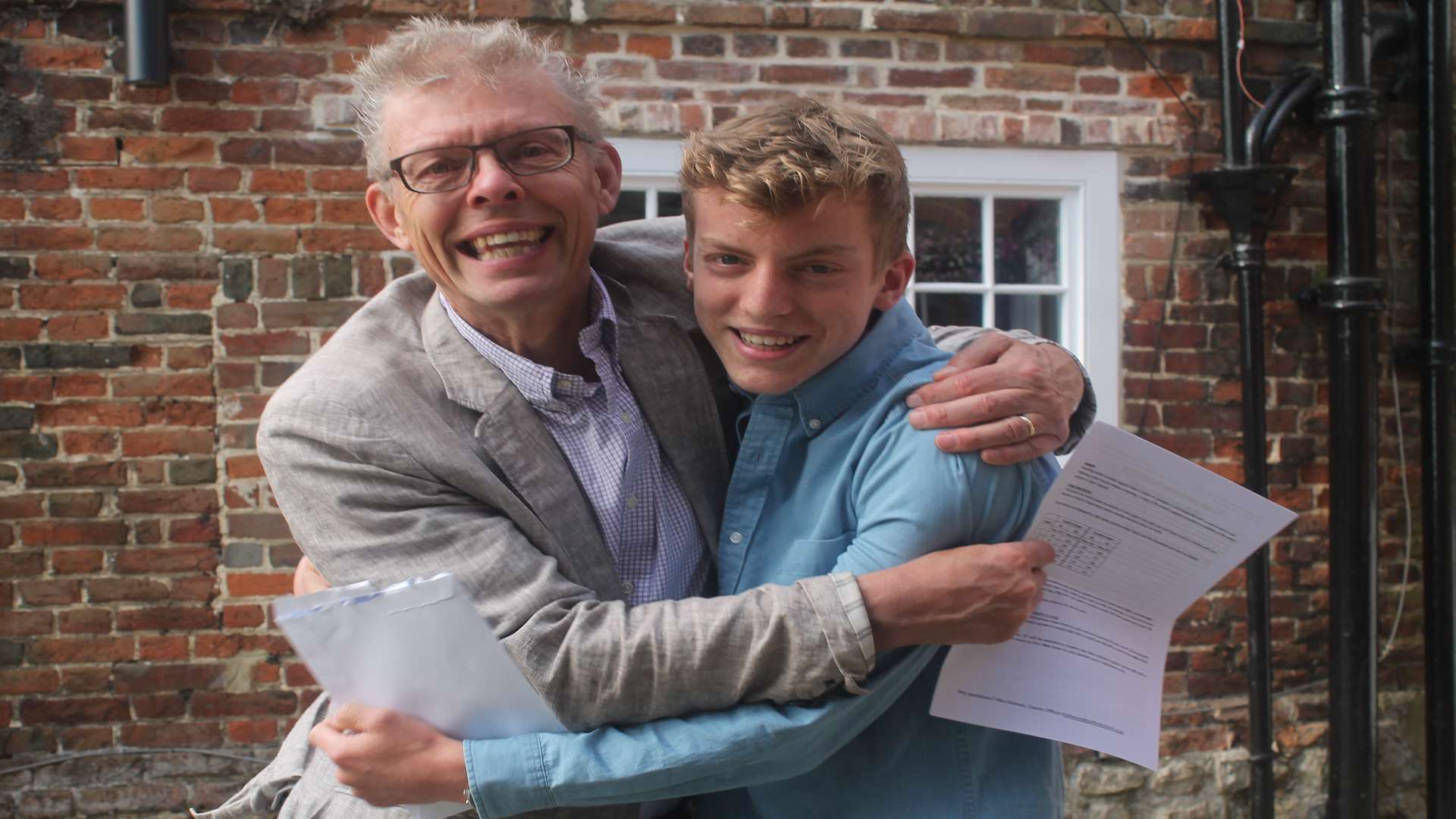 Euan Nicholls celebrates with his father Stuart at Ashford School