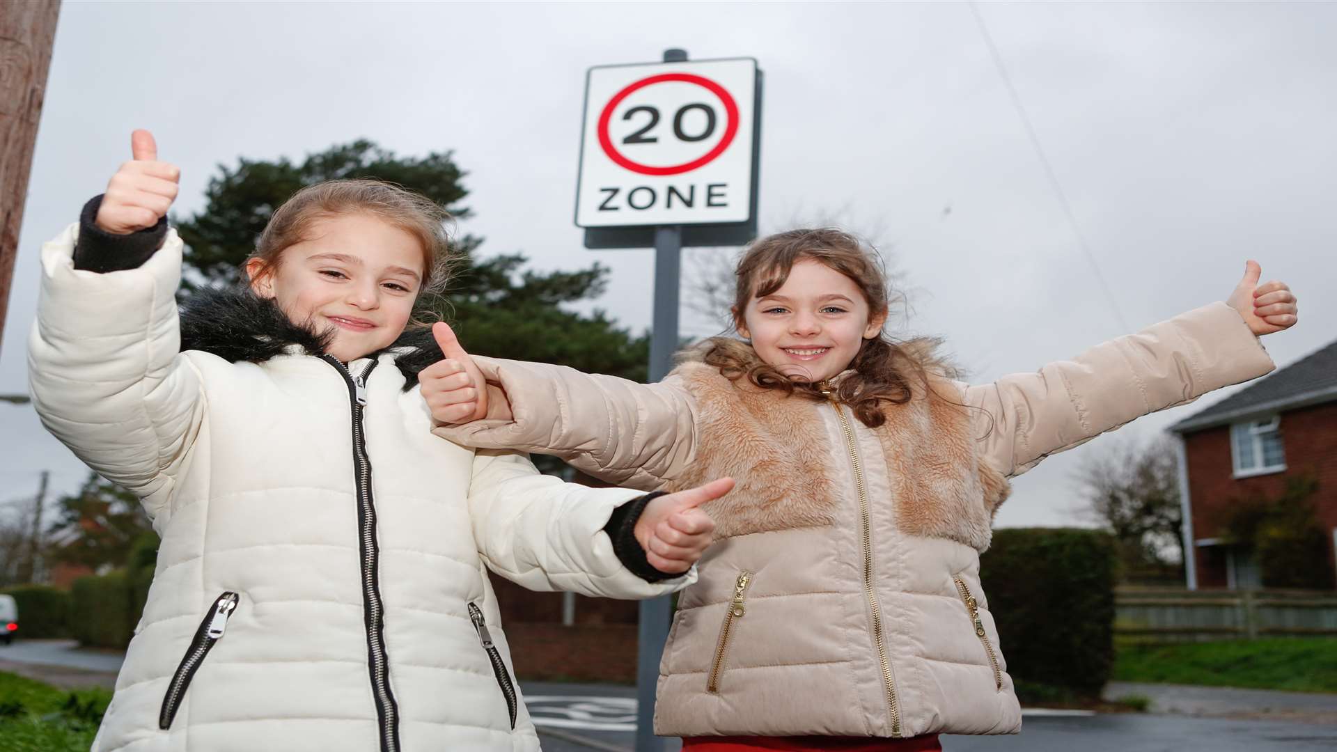 Twins Tiani and Lilly Alabaster-Oliver by the signs for the new 20mph zone