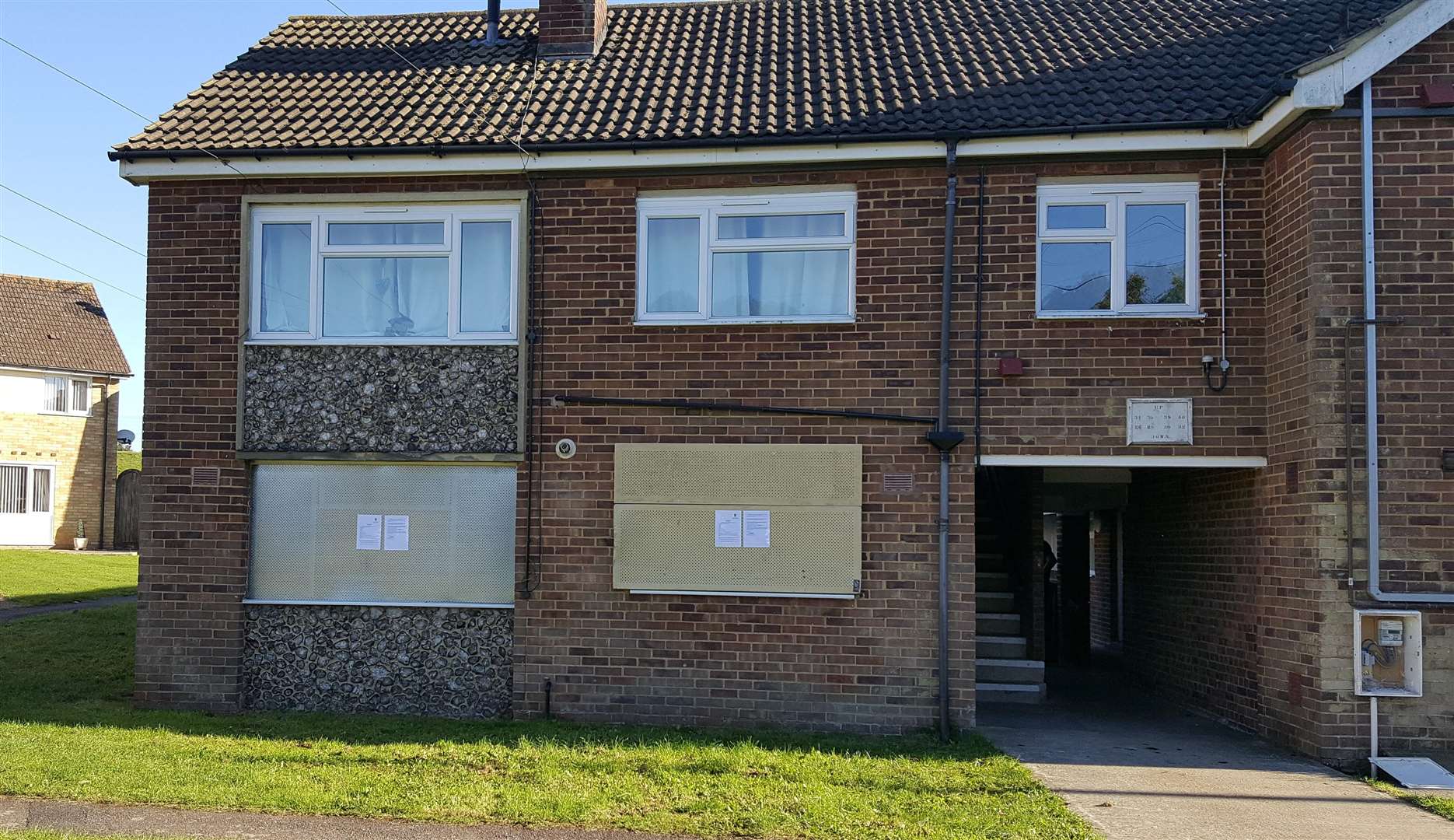 The flat has been boarded up, with police signs explaining the court order and the legal consequences of entering