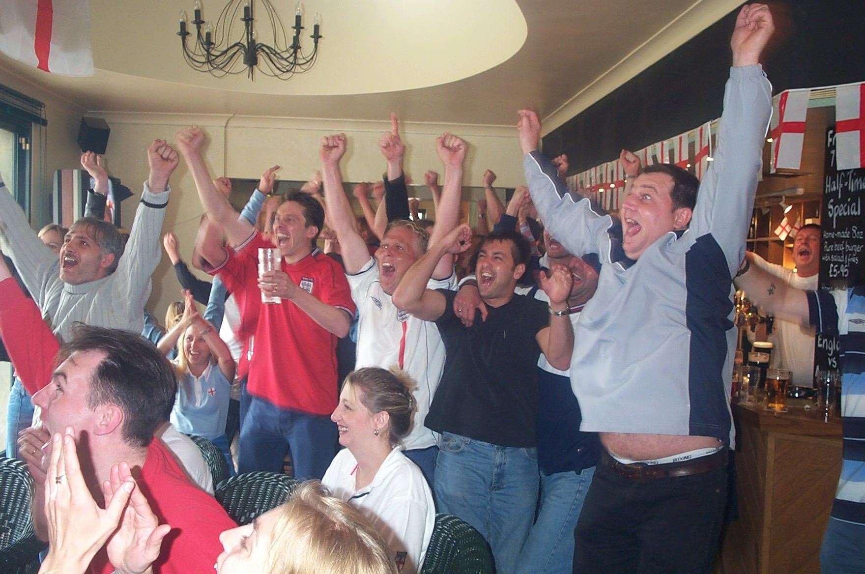 England fans celebrate at the Hole in the Roof in Deal as David Beckham scores his penalty winner against Argentina in 2002
