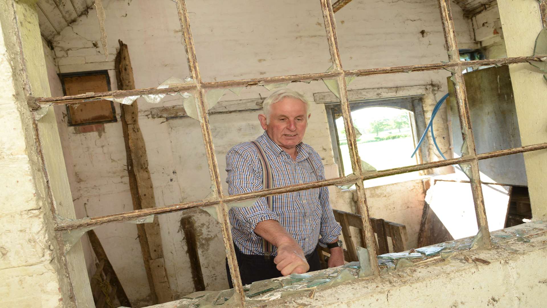 Geoffrey Homewood with one of the broken windows