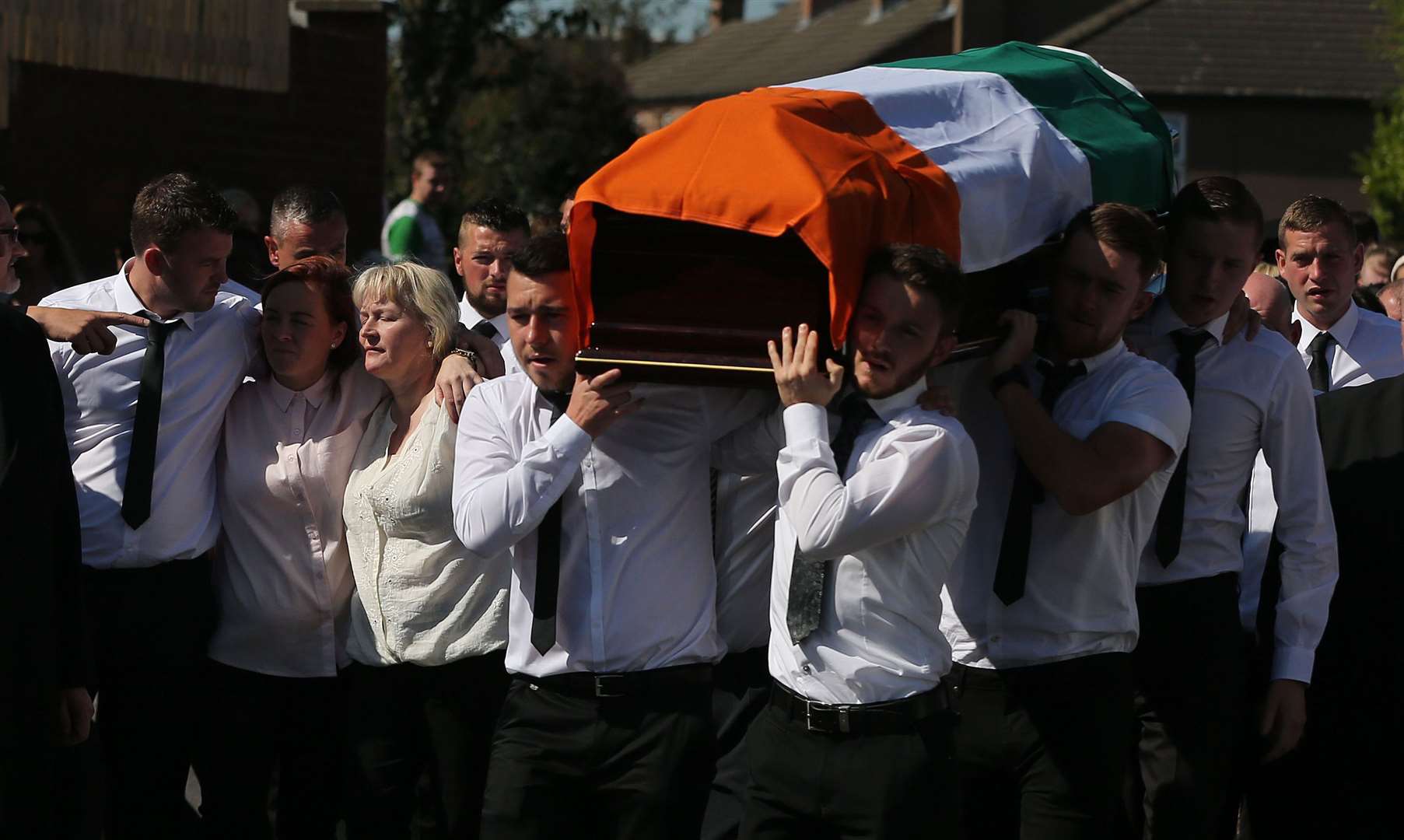 Kevin McGuigan’s widow Dolores (third from left) is comforted as his coffin in is carried to St Matthews Church in east Belfast for his funeral (Niall Carson/PA)
