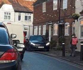 A car drives down the pavement towards a schoolgirl in Yalding