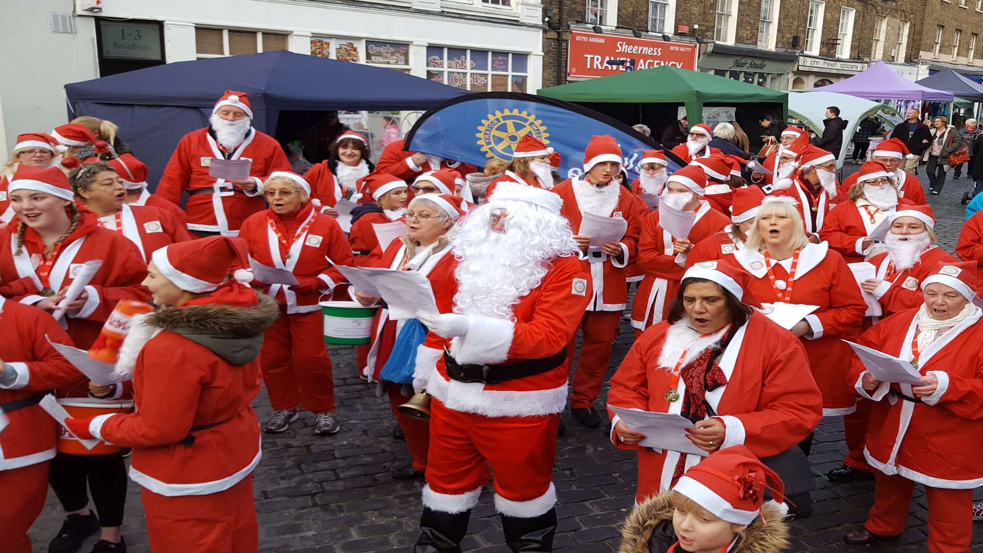 The Rotary Club Santas sang carols around the clocktower