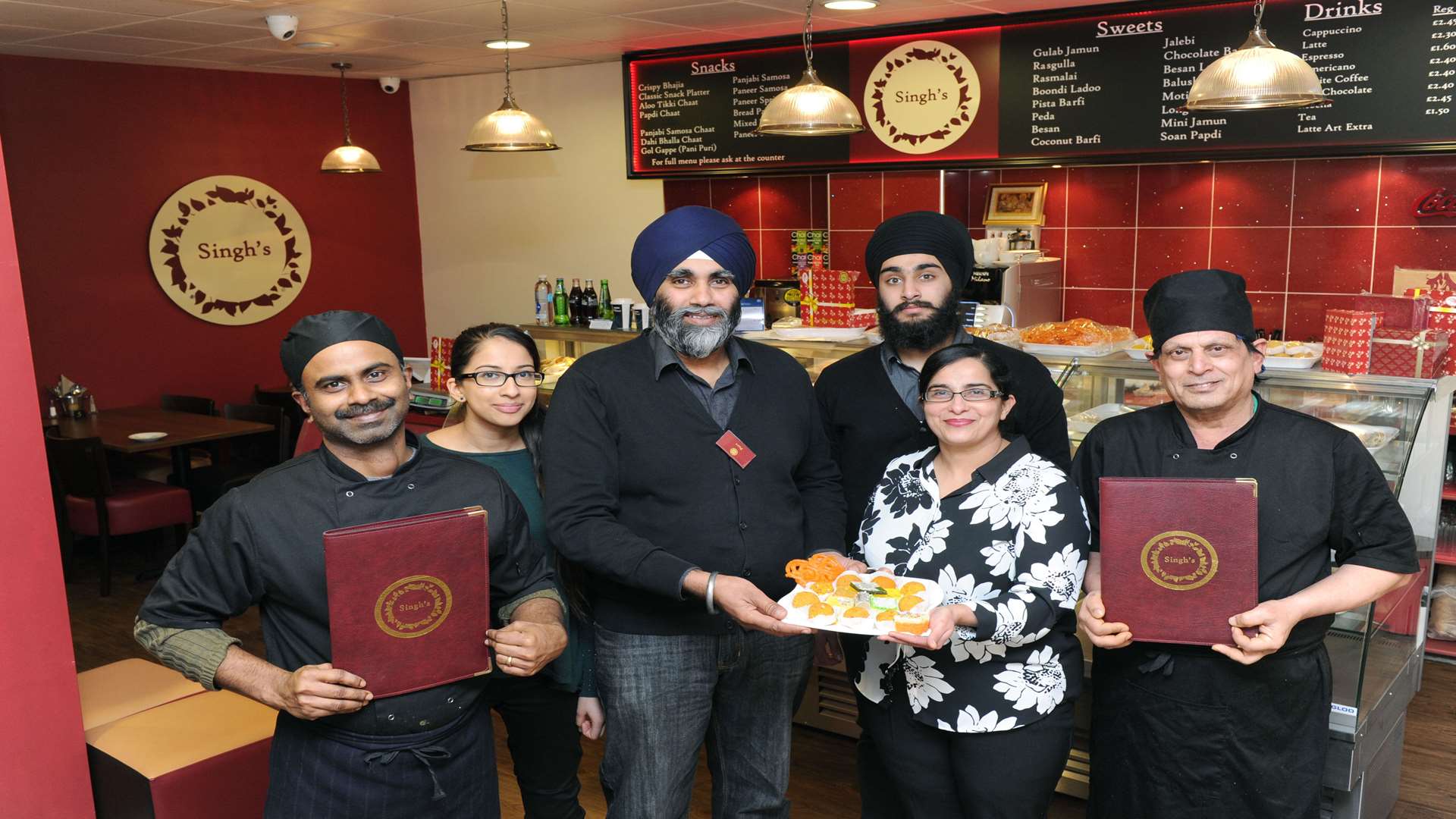 Restaurant owner Parvinder Singh Lalli (centre)