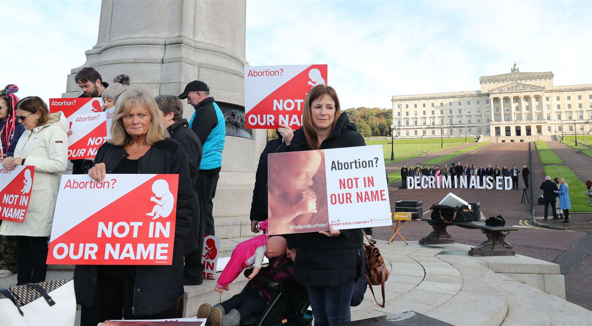 Anti-abortion and pro-choice activists take part in rival demonstrations outside Parliament Buildings at Stormont (PA)
