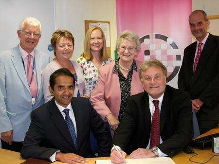 The contract is signed by chief executive of the trust Stuart Bain (seated on the right), with Subhashis Ghosh from GE Healthcare who has won the contact to supply the new equipment to the three hospitals