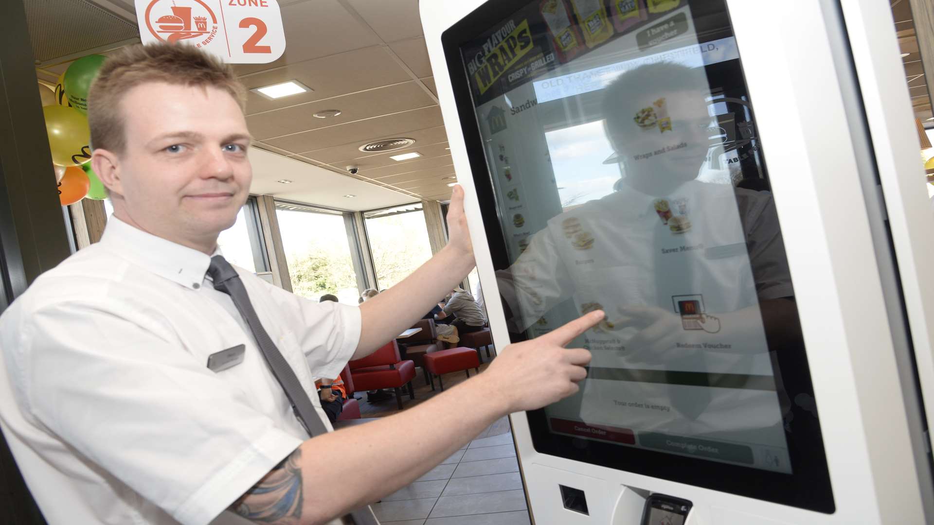 Manager Steve King demonstrates the new touch screen order taker at the refurbished Chestfield McDonald's.