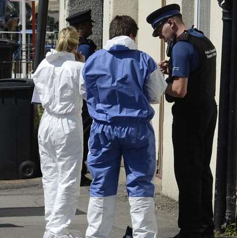 Forensics officers outside the flat in East Street, Tower Hamlets