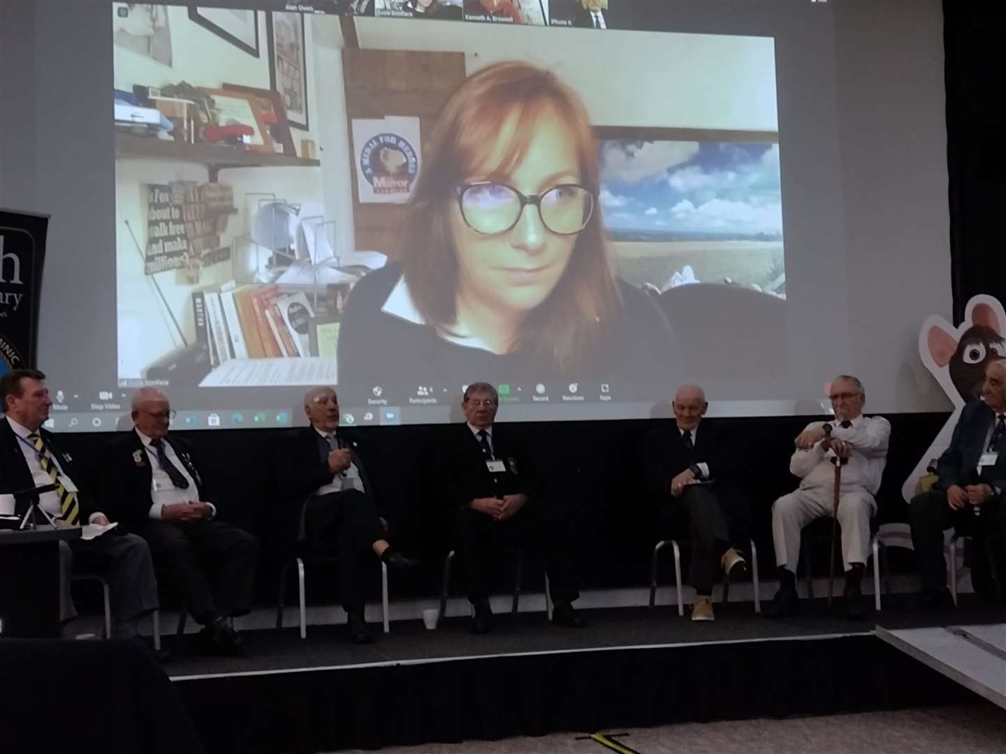 Terry Quinlan, centre stage, with other veterans at the conference, being interviewed by Susie Bonniface (on screen)