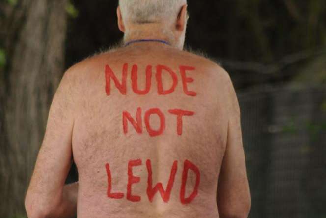 A rider on last year's naked bike ride gives a message to critics