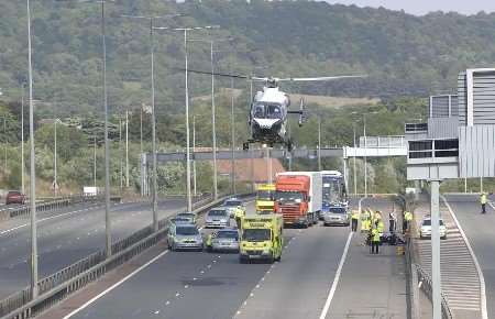 LIFT OFF: The Kent Air Ambulance leaving the scene on the way to hospital. Picture: PAUL DENNIS