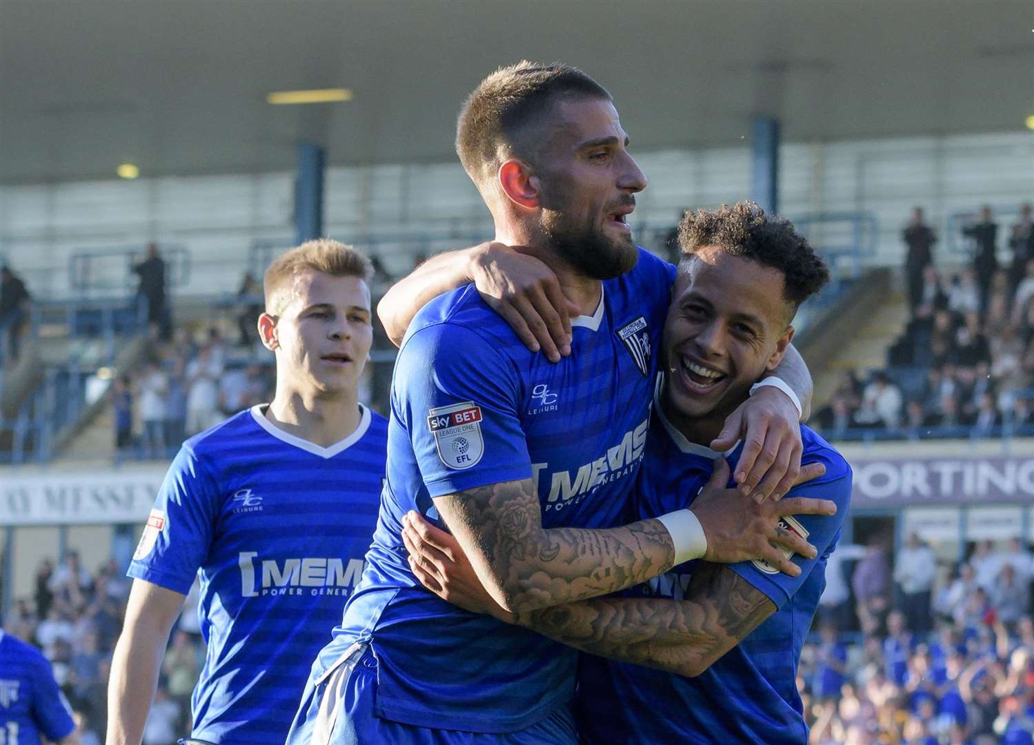 Max Ehmer hugs Elliot List after List scored Gillingham's fifth goal. Picture: Andy Payton