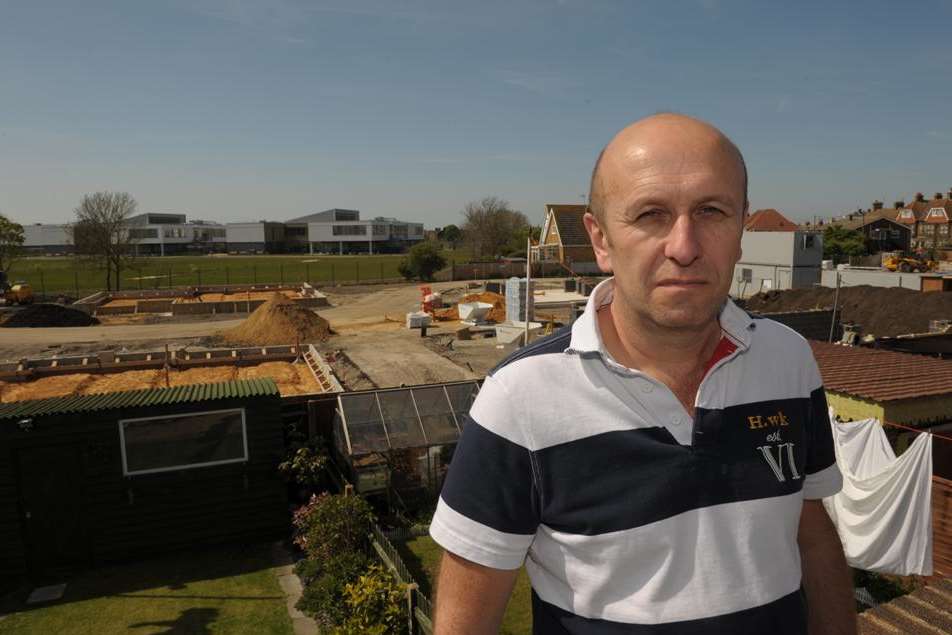 Wayne Featherstone and the development taking place behind his house in Seager Road, Sheerness