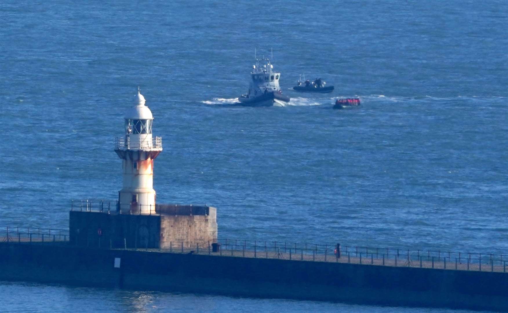 A small boat carrying people thought to be migrants is intercepted by Border Force vessels near the entrance to the Port of Dover in Kent (Gareth Fuller/PA)