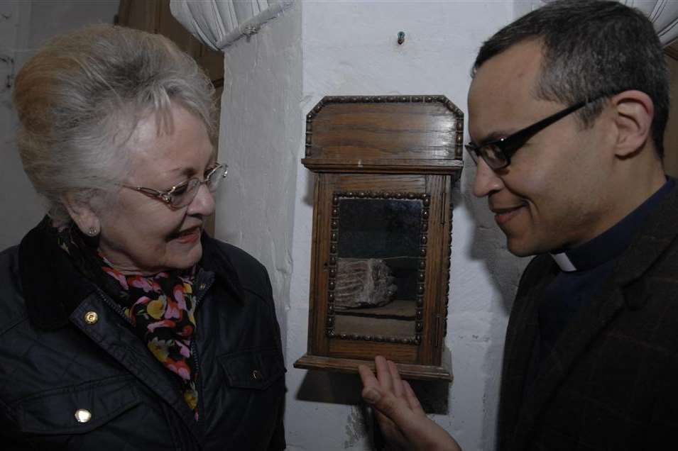 Church warden Maureen Jepson and The Rev George Rogers with the mammoth tooth on display in Bapchild church.