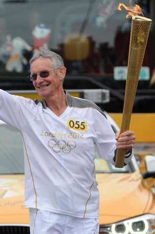 Ex-butcher Graham Cooper carries the Olympic torch through Seabrook