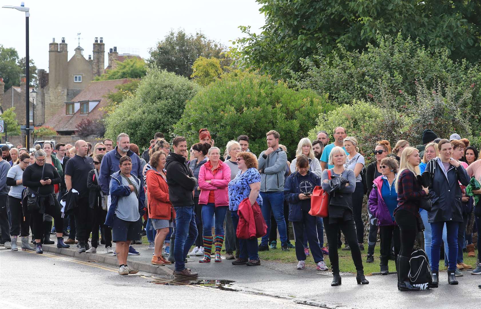 Members of the public gather to join the search teams outside the fire station in Sandwich