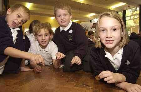 Youngsters from Class 1 lay out the coins. Picture: ANDY PAYTON