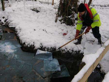 Environment Agency staff working in the snow to stop oil spilling into Maidstone water courses