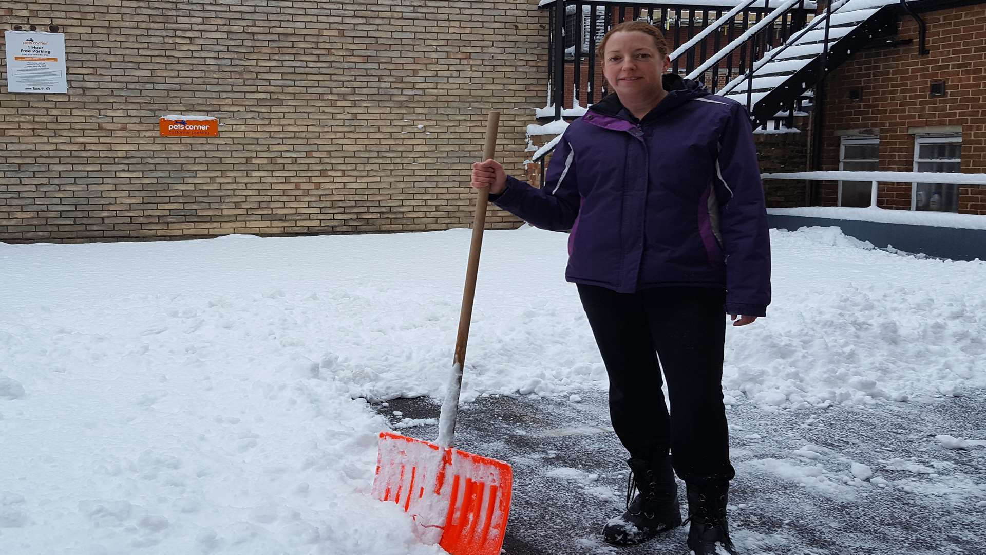 Louise Emmerick, assistant manager at Pets Corner in Week Street, clearing the snow