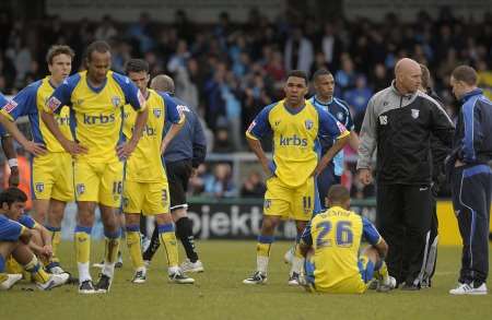 Gillingham players take in the news that they are relegated