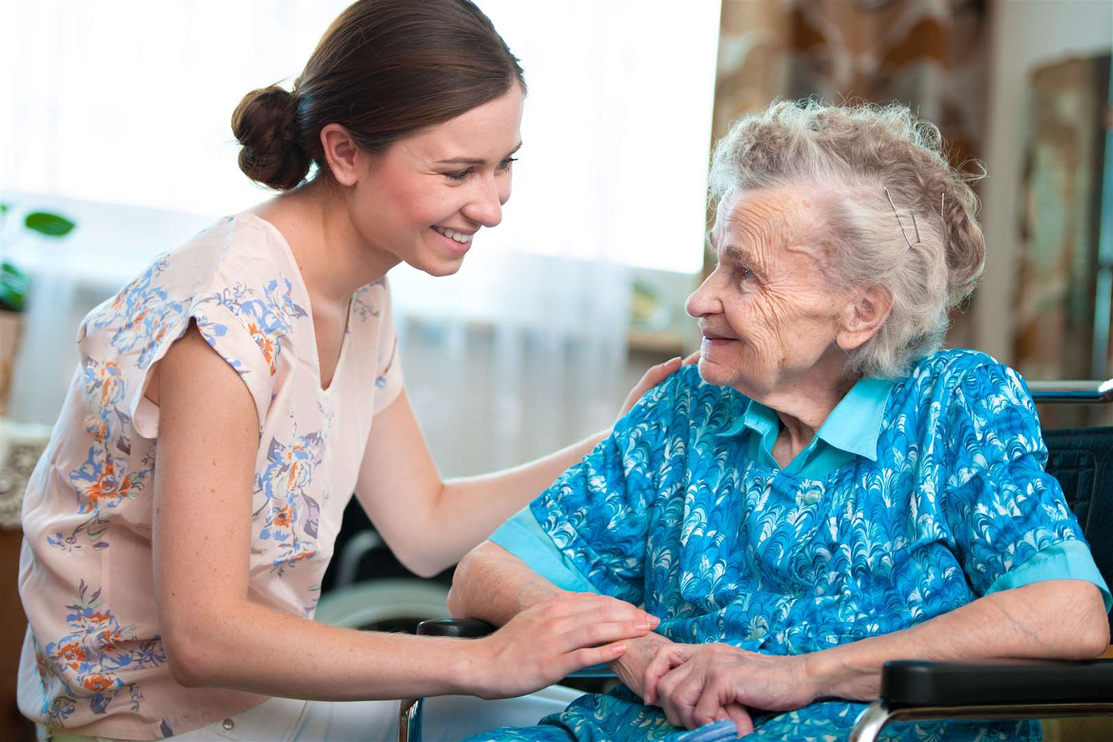 Senior woman with her caregiver at home. Stock picture