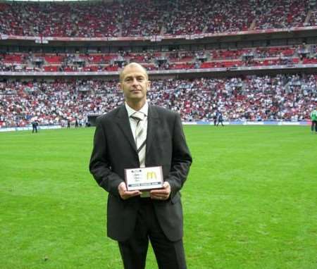 Manager Gary Axford shows off the award at Wembley