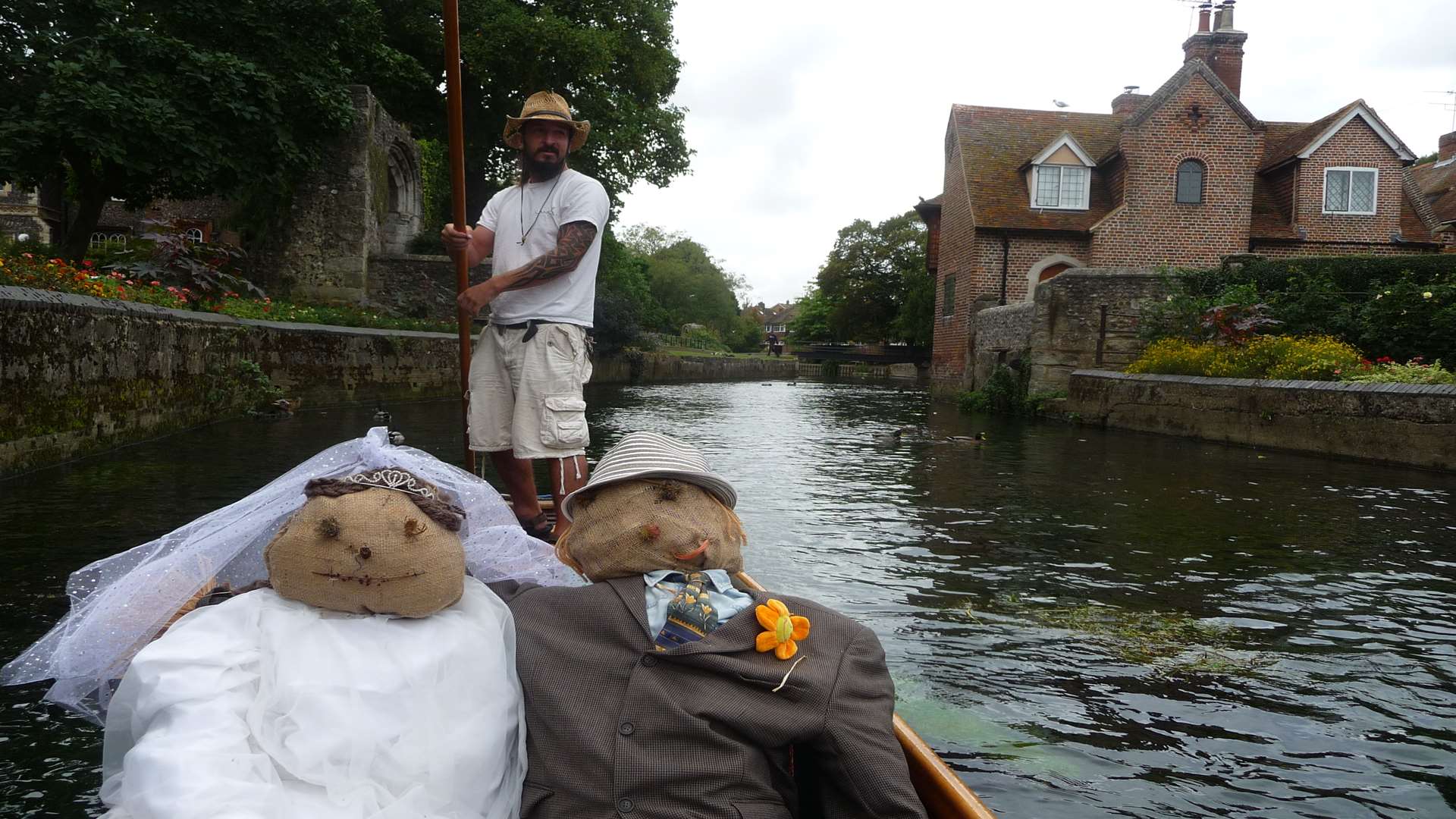 A scarecrow bride and groom-to-be take a trip on the river through Westgate Gardens
