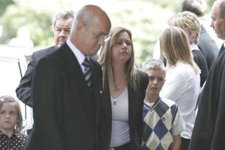 Widow Deena Harvey and her children Dione and Dylan at Mr Payne's funeral. Picture: PETER STILL