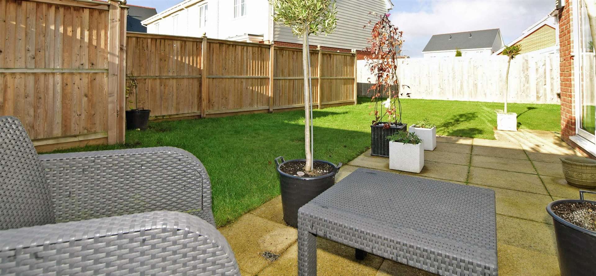 Back garden has a patio and a level lawn