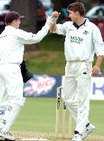 Niall O'Brien and Simon Cook celebrate the wicket of Gloucestershire's Carl Greenidge.