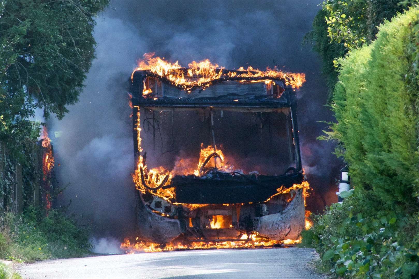 black tour bus with red flames