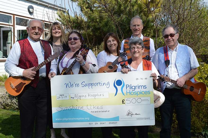 The presentation from Sunshine Ukes to the Pilgrims Hospices. Pictured are Colin Kidd with Sara Scriven from Pilgrims Hospices, Lynda Borley, Carole Barrett, Graham Jackson, Jan Croucher and Peter Croucher