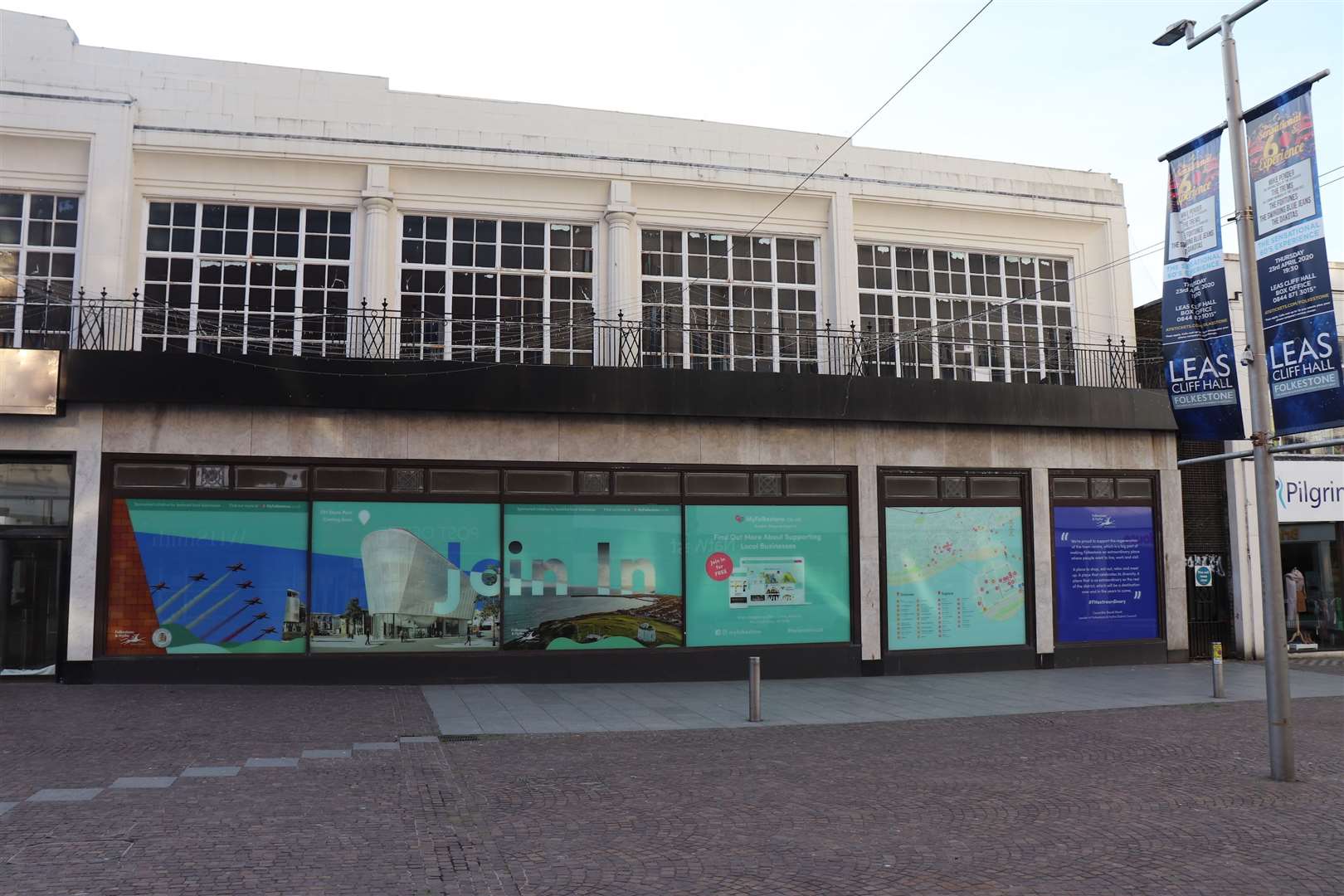 The first panels of the new vinyl window display at Folkestone's former Debenhams store have been installed