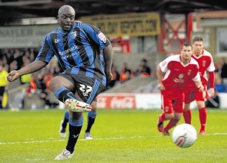Adebayo Akinfenwa scores from the penalty spot for the fourth Gillingham goal against Accrington Stanley