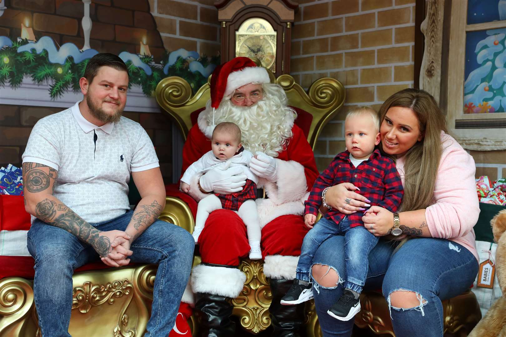 Santa's grotto at Hempstead Valley Shopping Centre. Pictured are Aaron Elms, Zac Elms, one, Ariana Elms, five months and Zoe Elms with Santa. Picture: Andy Jones.