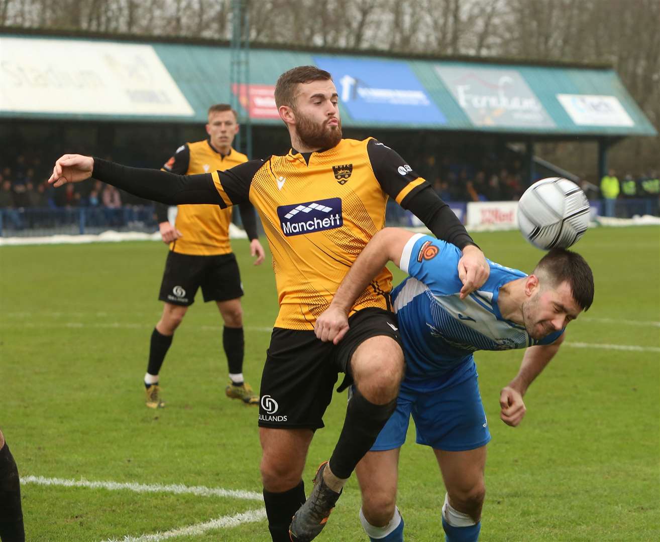 Tom Parkinson tussles with Maidstone midfielder Regan Booty in the Boxing Day derby at Longmead Picture: Dave Couldridge