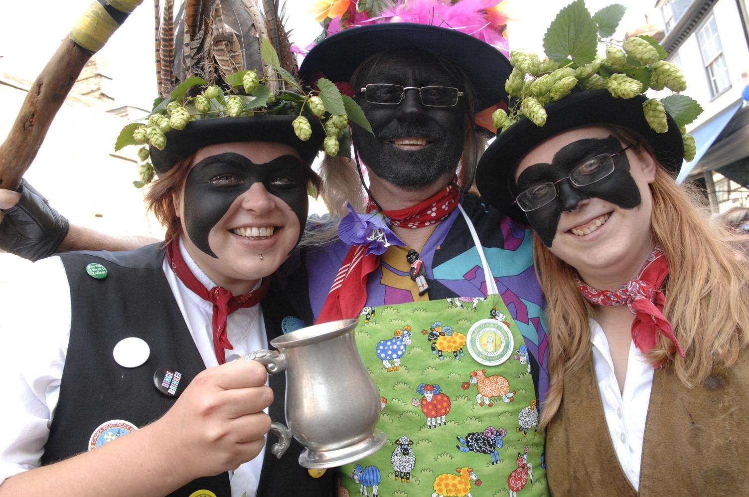 Emma Standen, Steve Hoad and Ruth Taylor of Dead Horse Morris take a break from dancing at the Faversham Hop Festival last year. Picture: Chris Davey.