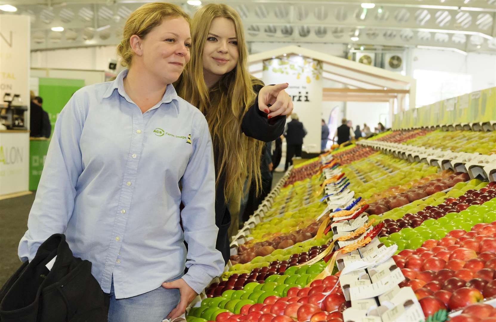 Eve Hart, and Amy Bradley of ACS Farm Image admire the long lines of competition entries at the National Fruit Show