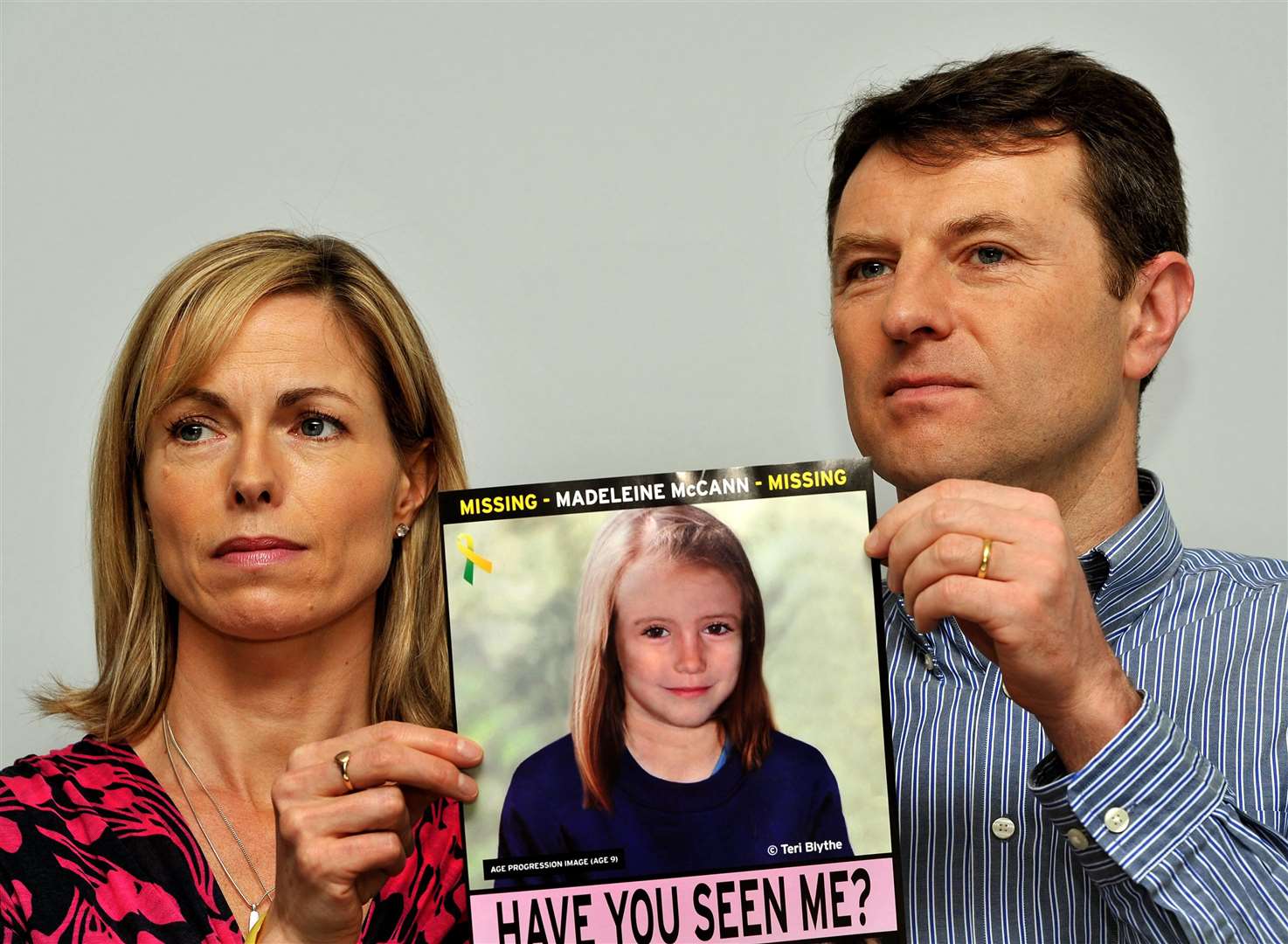 Kate and Gerry McCann in 2012 holding an image of what Madeline might look like as an older girl (John Stillwell/PA)