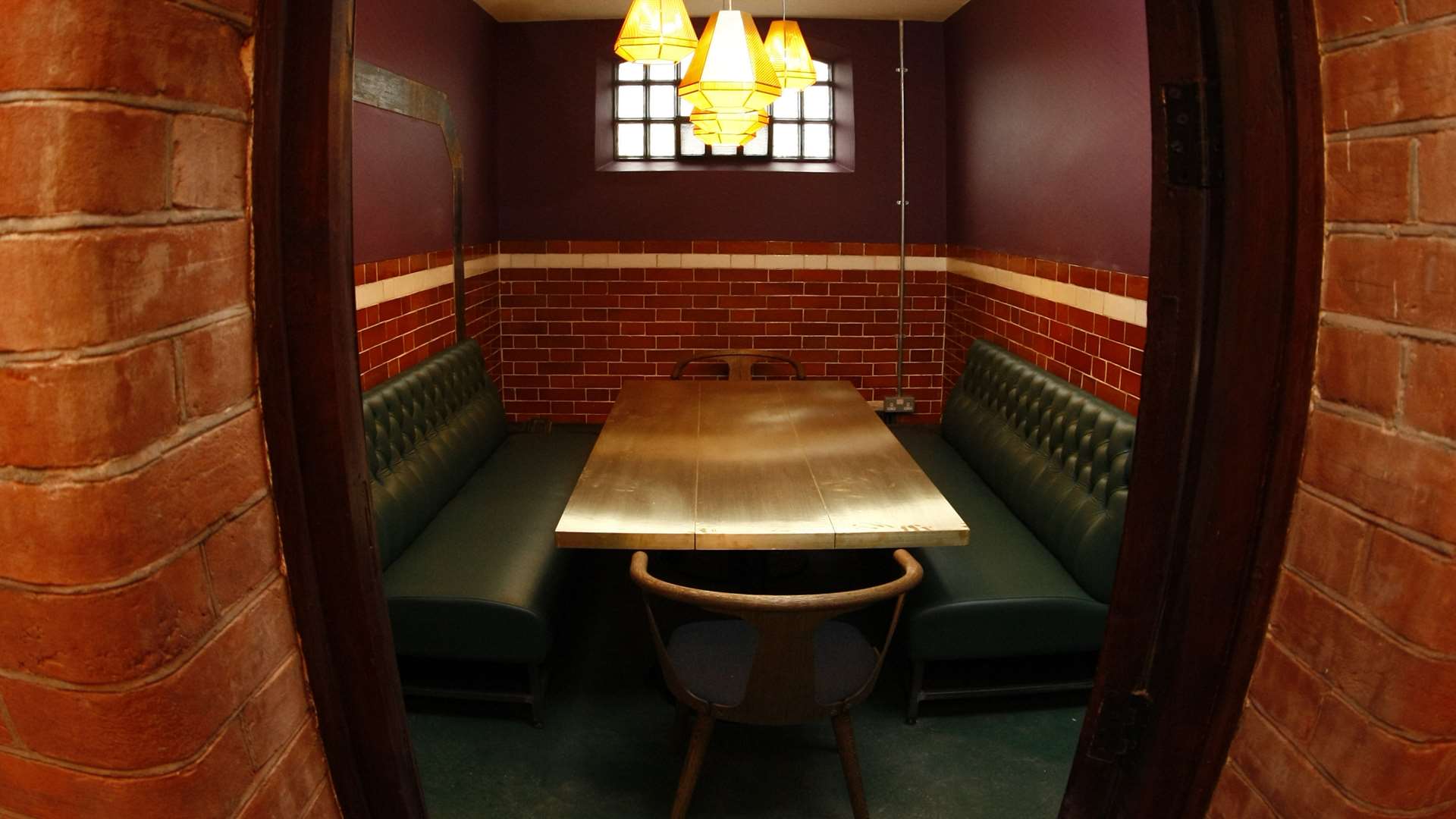 One of the private dining rooms in an old cell with the original door