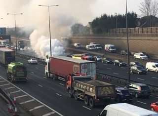 Smoke billowing at the scene of the M25 car fire. Picture: Eddy Guard