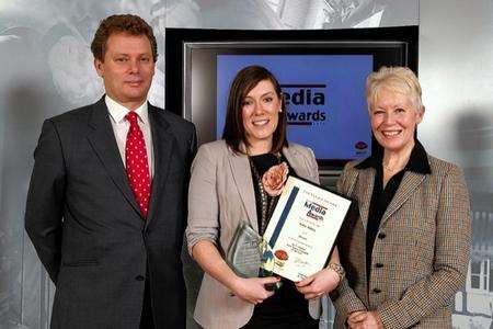 Katie Alston receives the Kent Young Journalist of the Year award for the second year running from Jonathan Neame (left) and Barbara Sturgeon (right).