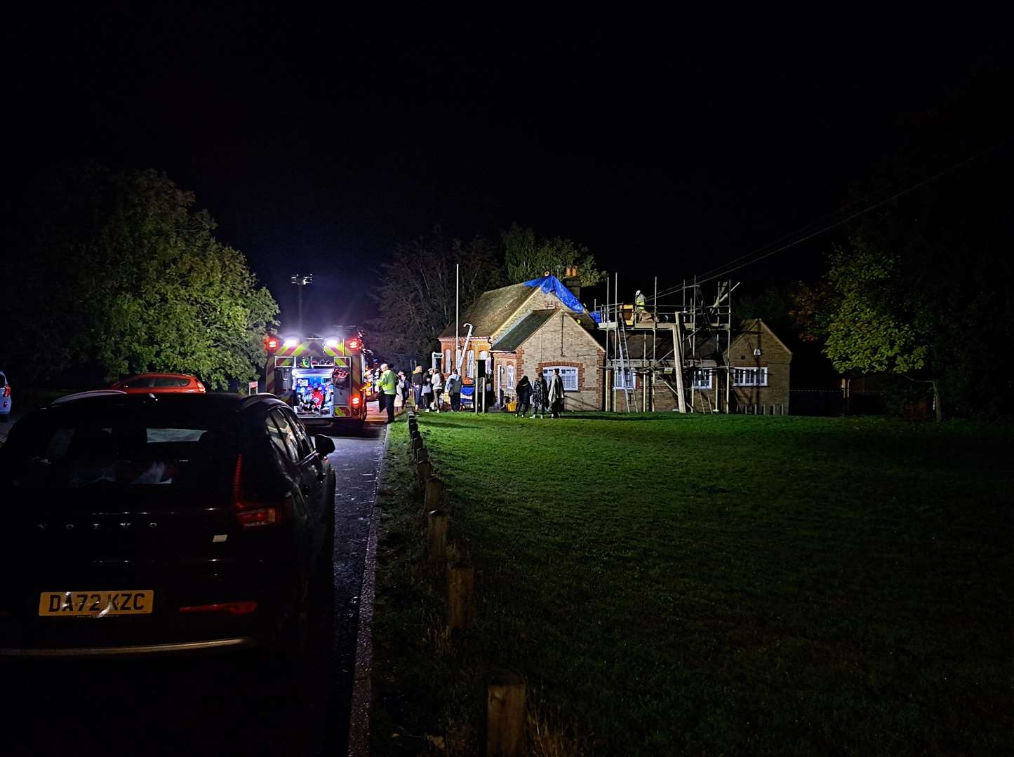 Fire crews and a group of villagers at Rodmersham Primary School after the fire was put out
