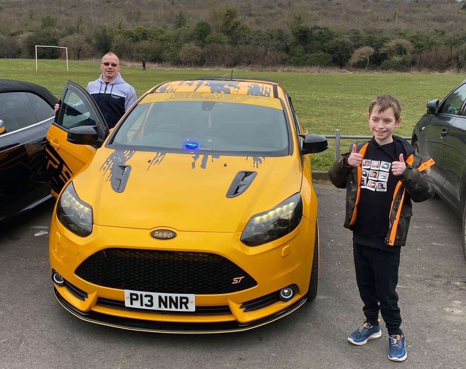 The birthday boy posed with all the cars. Picture: Kerry North
