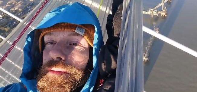 Just Stop Oil protester Morgan Trowland in a hammock on the QEII bridge. Picture: Just Stop Oil