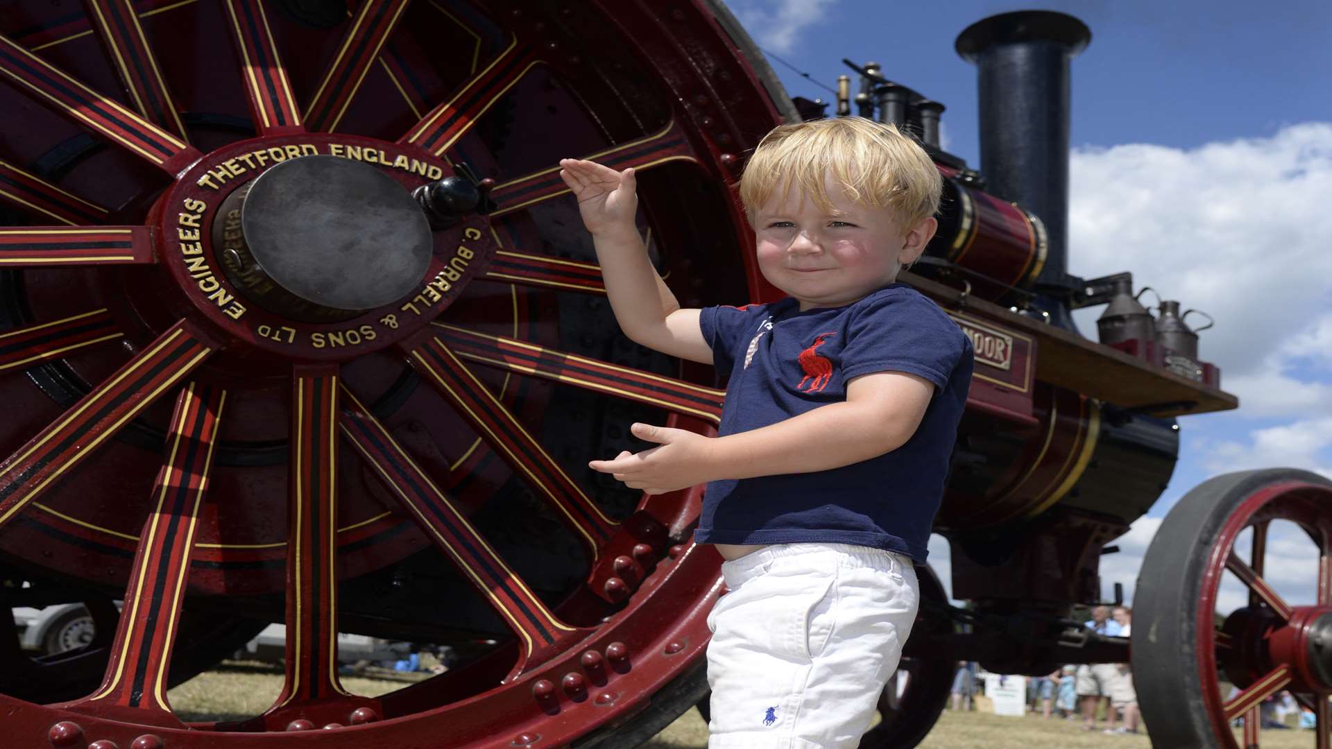Jake Skinner, three, admires one of the many traction engines at the Weald of Kent Steam Rally at Woodchurch. Picture: Chris Davey