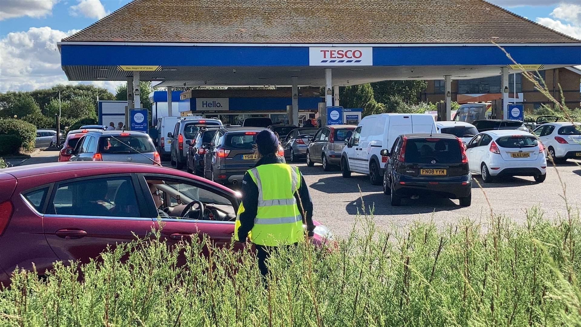Staff try to round up motorists queuing for fuel at Tesco, Sheerness